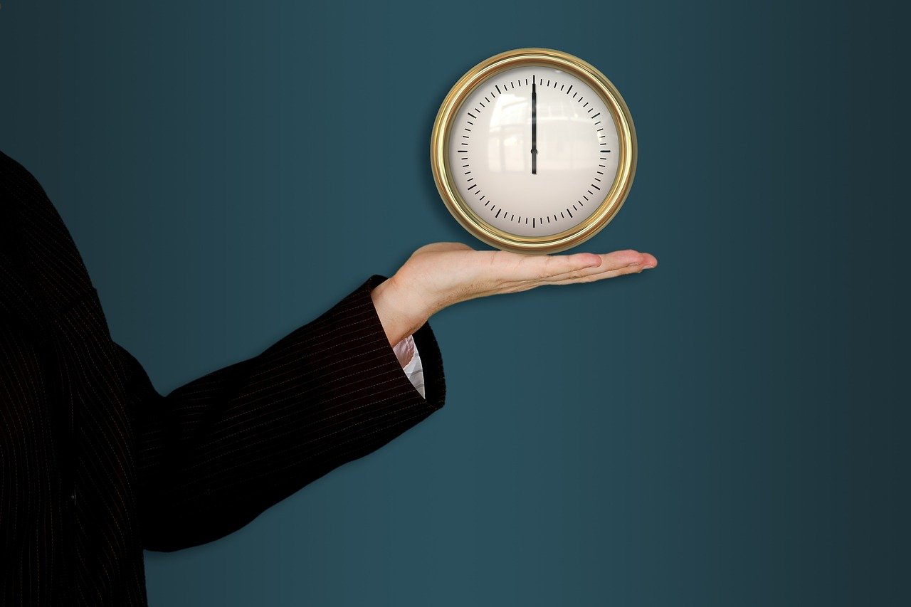 A person holding a clock in their hand, symbolizing how poor time management effects on lifestyle and daily balance.